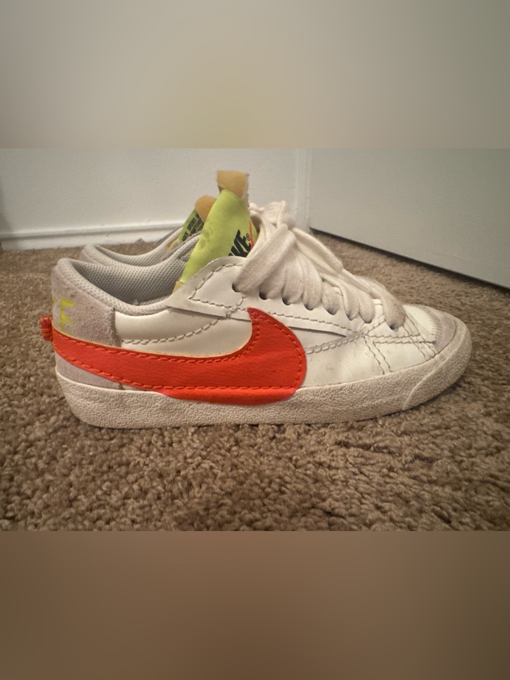 Nike White Sneakers with Bright Orange Swoosh and Neon Yellow Tongue